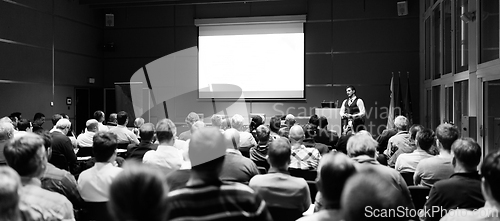 Image of Speaker giving presentation on business conference event.