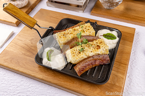 Image of Two pieces of fried polenta with bacon