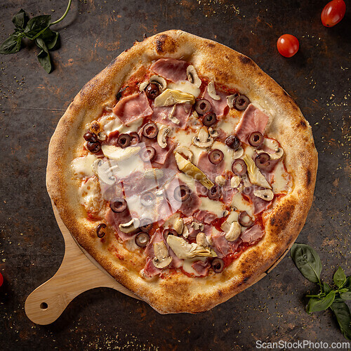 Image of Italian pizza on rustic metal table
