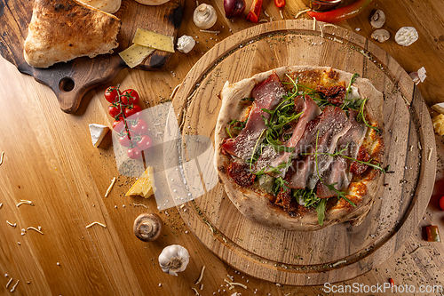 Image of Delicious pizza with prosciutto