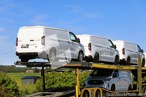 Image of Vehicle Carrier Transports White Ford Transit Vans