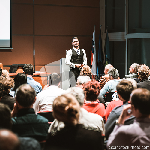 Image of Business speaker giving a talk at business conference meeting event.