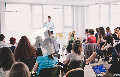 Image of Speaker giving presentation on business conference meeting.
