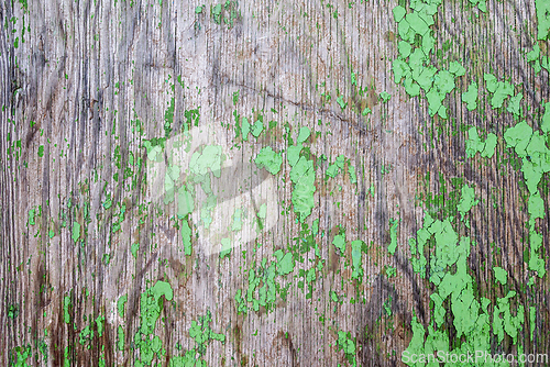 Image of Old wooden surface with small areas of green paint.