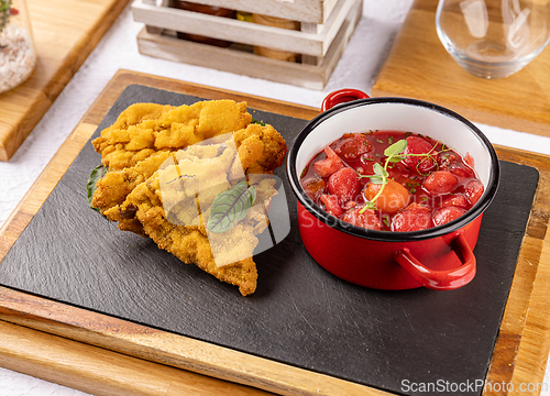Image of Breaded meat with tomato salad