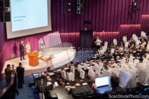 Image of Defocused image of speakers giving a talk at business meeting