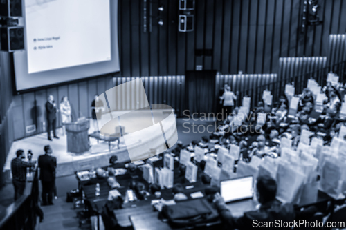 Image of Defocused image of speakers giving a talk at business meeting