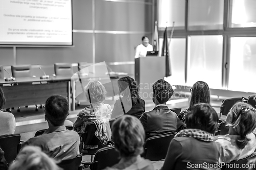 Image of Woman giving presentation in lecture hall at university.