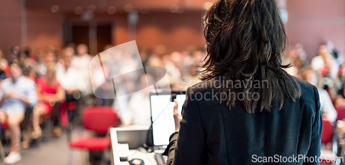 Image of Public speaker giving talk at Business Event.