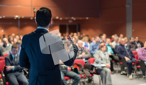 Image of Speaker giving a talk at business conference meeting.