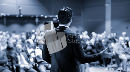 Image of Speaker giving a talk at business conference meeting.