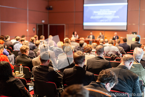Image of Audience in lecture hall participating at business event.