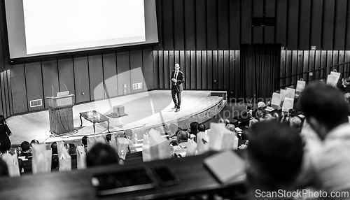 Image of Speaker giving presentation on business conference event.