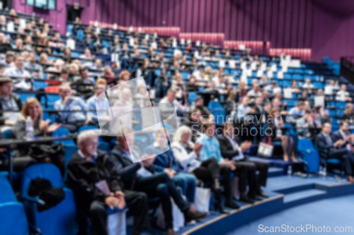 Image of Blurred, unrecognizable, business people in the audience listening to lecture in conference hall. Business and Entrepreneurship concept.