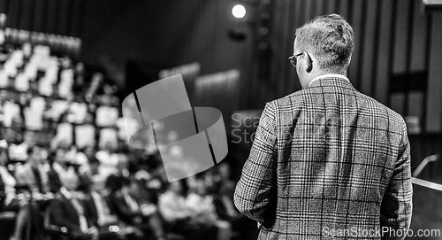 Image of Public speaker giving talk at Business Event.