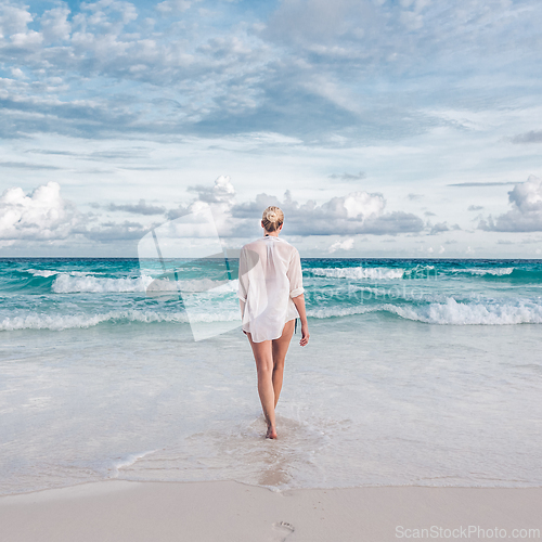 Image of Woman on summer vacations at tropical beach of Mahe Island, Seychelles.