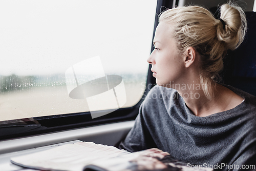 Image of Lady traveling by train.