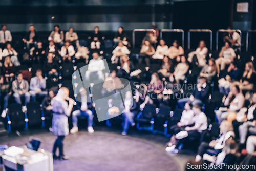 Image of Blurred, unrecognizable, business people in the audience listening to lecture in conference hall. Business and Entrepreneurship concept.