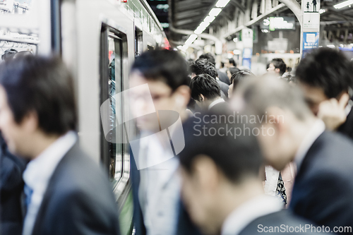 Image of Business people traveling by Tokyo metro.