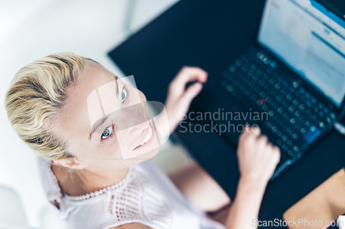 Image of Business woman working from home.