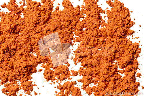 Image of A layer of orange powder on a white background