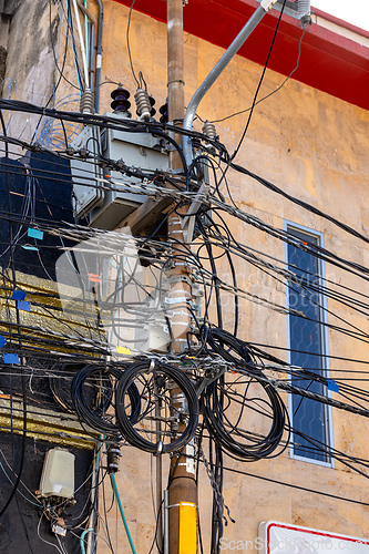 Image of City power and phone lines, utility pole chaotic crowded with electrical cables. Santa Marta Colombia