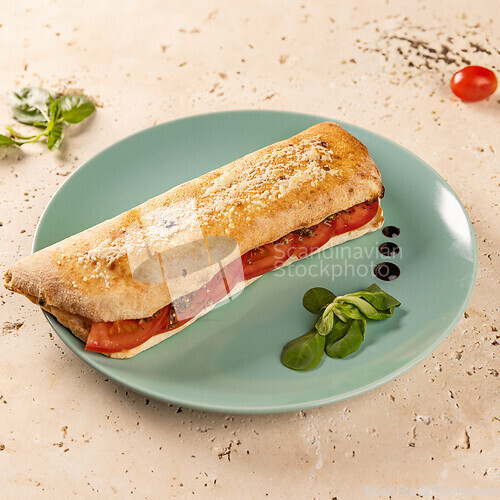 Image of Delicious panini with juicy tomatoes and herbs
