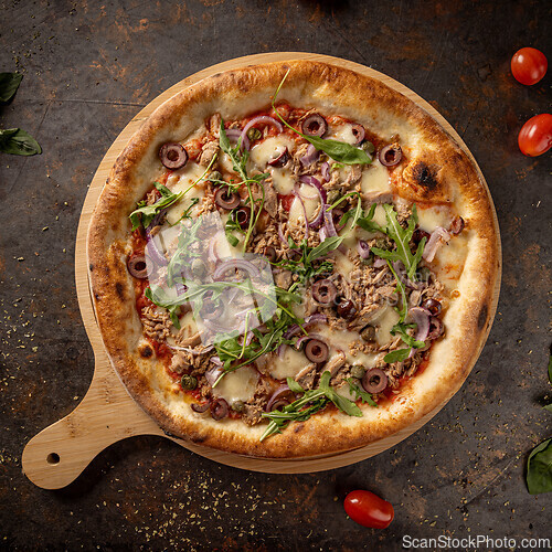 Image of Freshly baked tuna pizza with mozzarella
