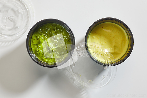 Image of two sauces in plastic cups