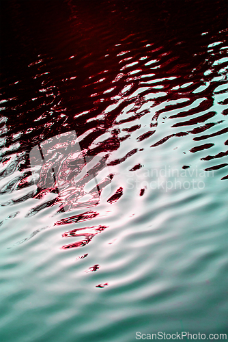 Image of Red green background. Small ripples on the surface.