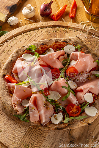 Image of Appetizing homemade pizza with mortadella