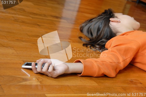 Image of Teen girl lying on floor