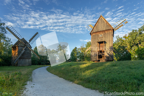 Image of Old wooden windmills in the morning sun