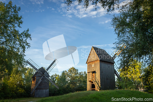 Image of Old wooden windmills in the morning sun