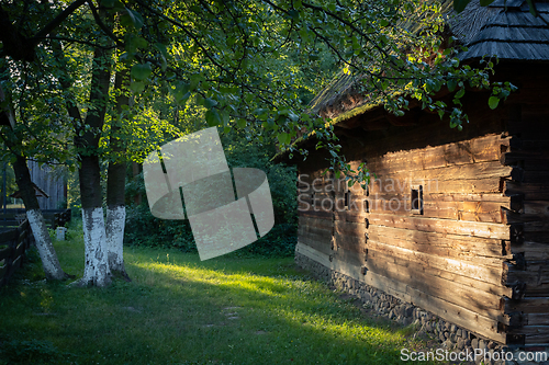 Image of An old wooden cottage in the morning sun