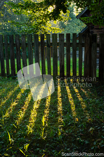 Image of An old wooden fence in the morning sun