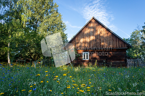 Image of An old wooden cottage in the morning sun