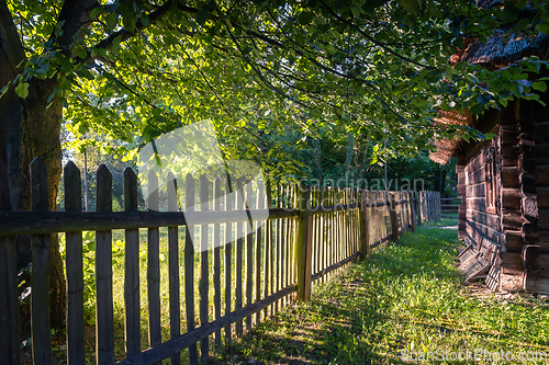 Image of An old wooden cottage in the morning sun
