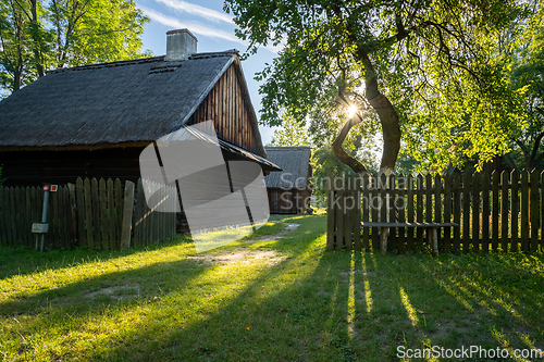 Image of An old wooden cottage in the morning sun