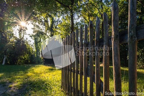 Image of An old wooden cottage in the morning sun