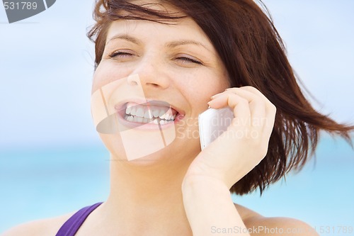 Image of happy woman with white phone