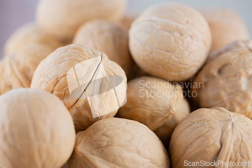 Image of Pile of unpeeled walnuts close-up