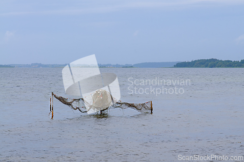 Image of Fishing Gear At Rest: A Tranquil Evening Overlooking The Calm Wa
