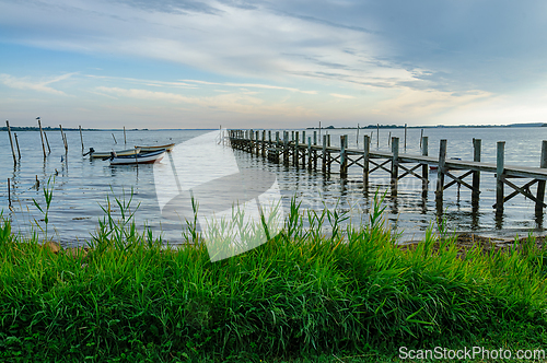 Image of Tranquil Evening on the Water With Relaxing Boats and Scenic Doc