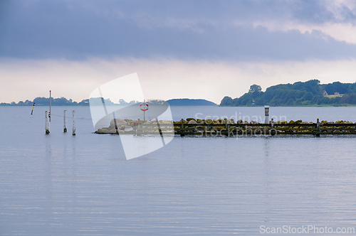 Image of Tranquil Waterscape at Dusk Featuring a Dock and Serene Island V