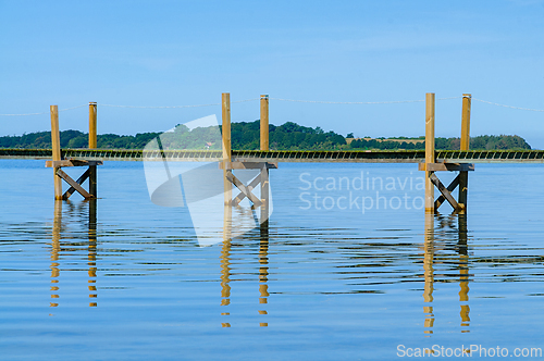 Image of Tranquil Early Morning at the Serene Lakeside Dock Under Clear B