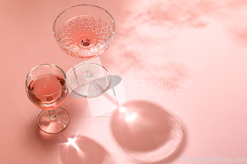 Image of various glasses on pink background