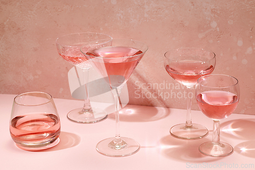Image of various glasses of pink drink