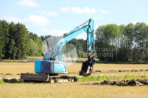 Image of Blue Compact Excavator at Work 