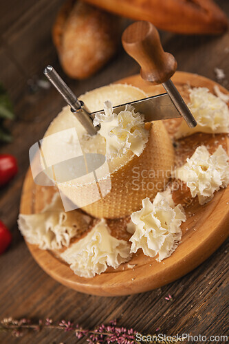 Image of Slicing tete de moine cheese